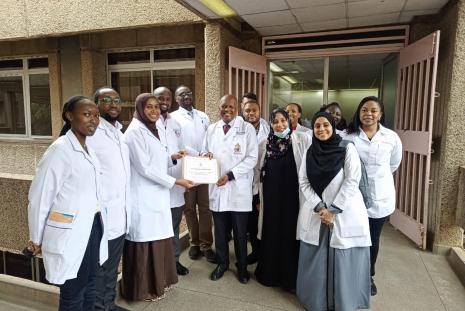 Dr Uba Hemed receiving a certificate from the chairman,  Department of Ophthalmology